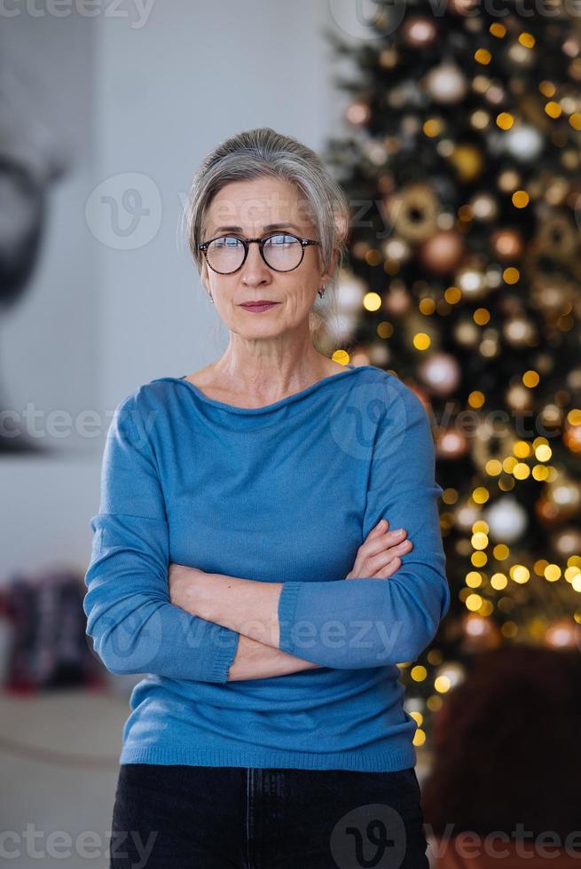 serious mature woman with her head held high looking at camera photo