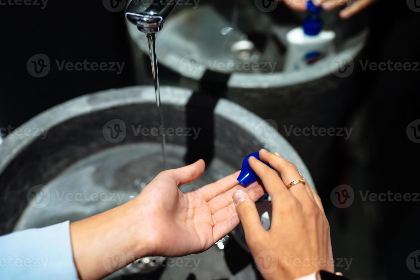 Man washing hands to protect against the coronavirus photo