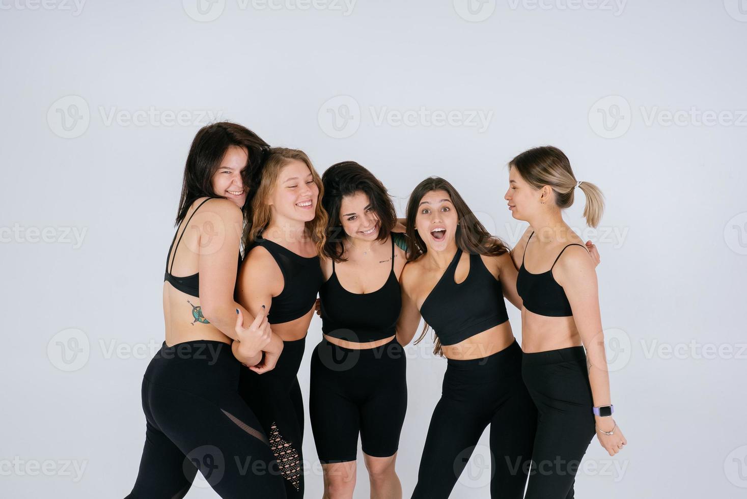 diverse models laughing, enjoying time together, look at camera photo