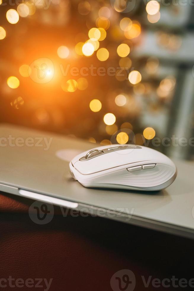Modern wireless computer mouse on wooden table photo