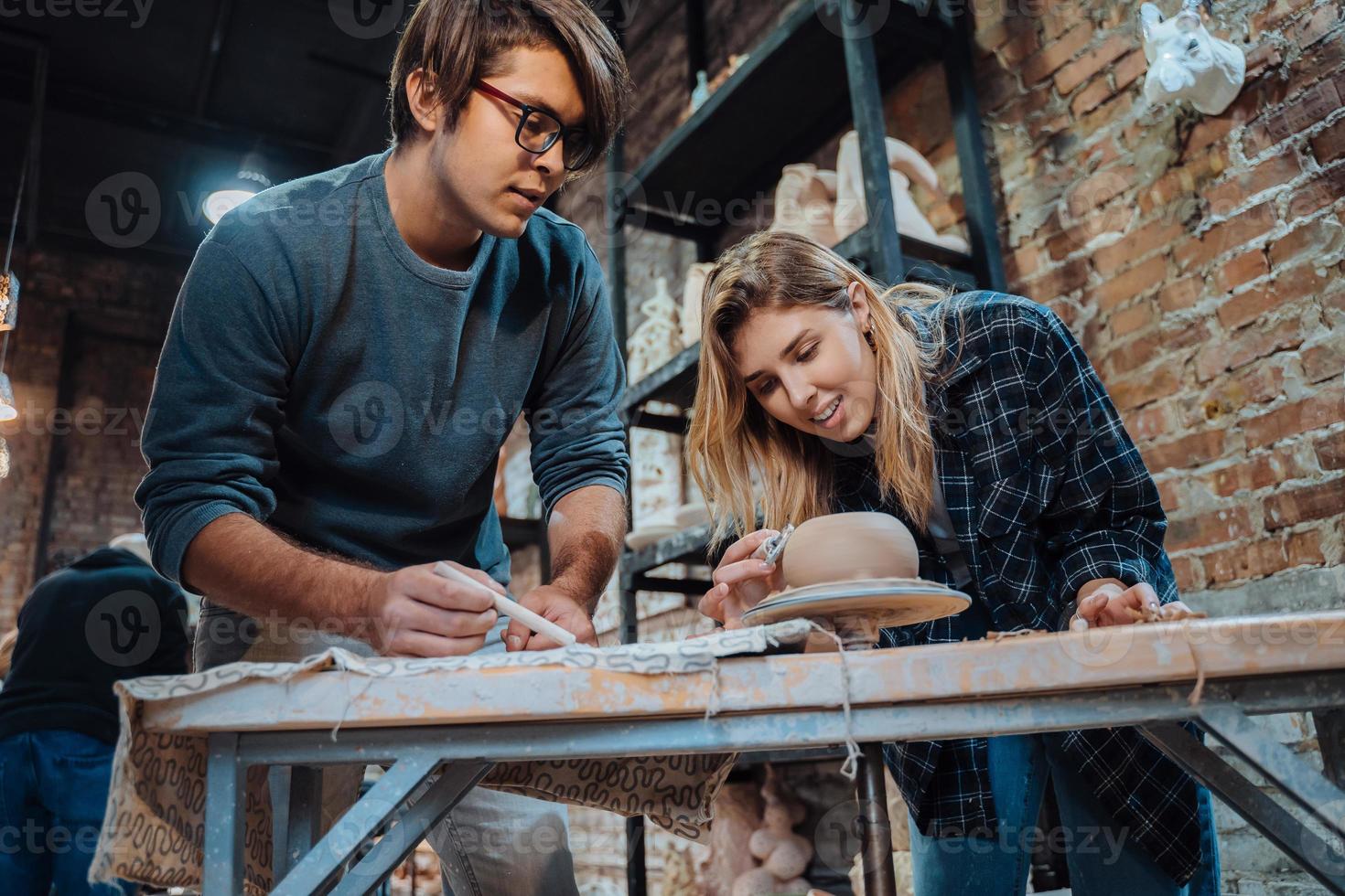 Making a handmade clay pot in the workshop. Pottery lesson, hobby. photo