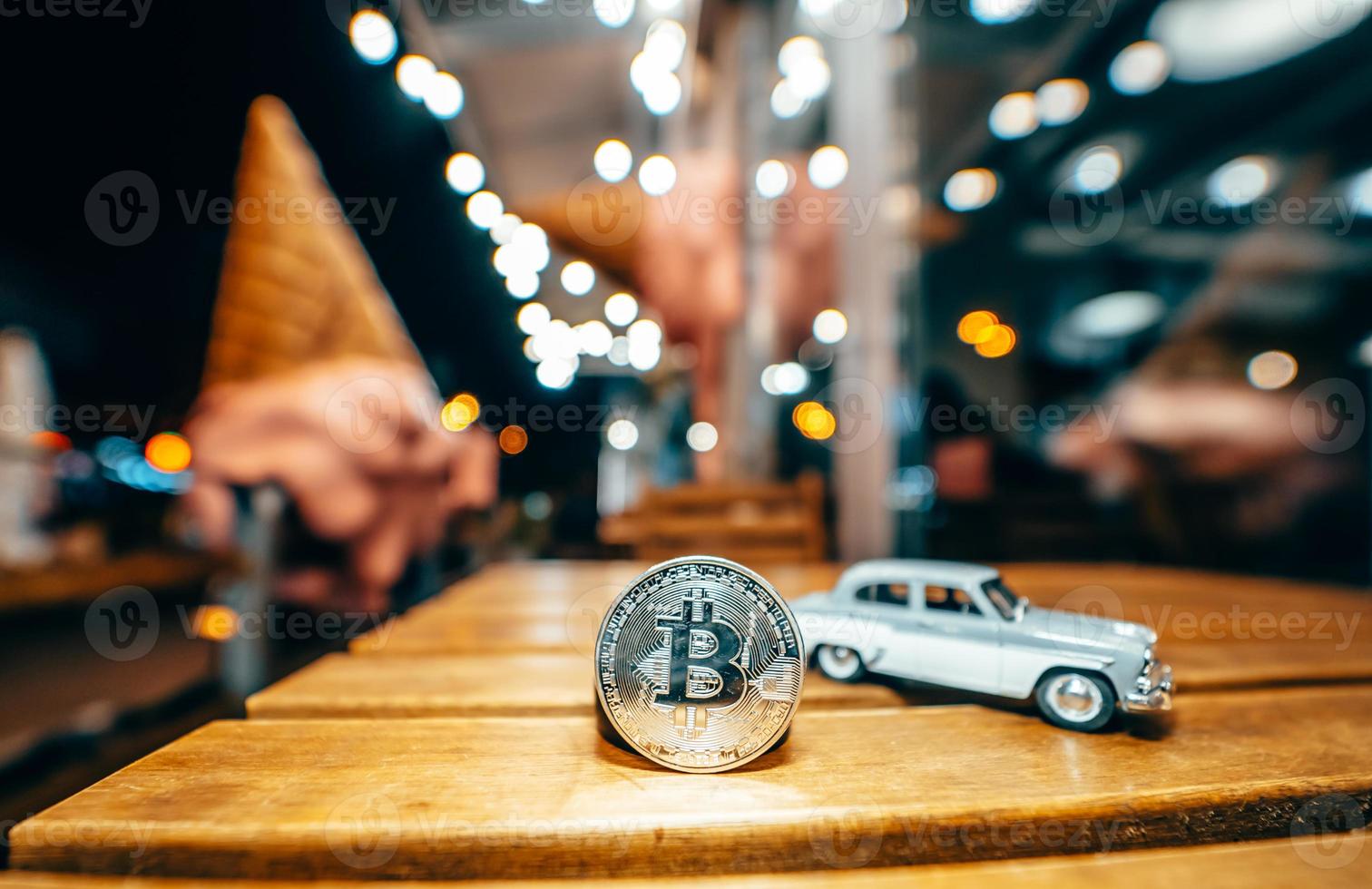 Silver bitcoin and Moskvich 401 on the table, glowing background photo