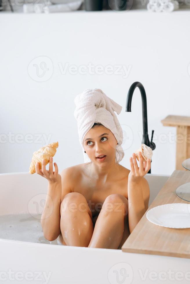 Luxury fashion woman in the morning take breakfast lying in bath photo