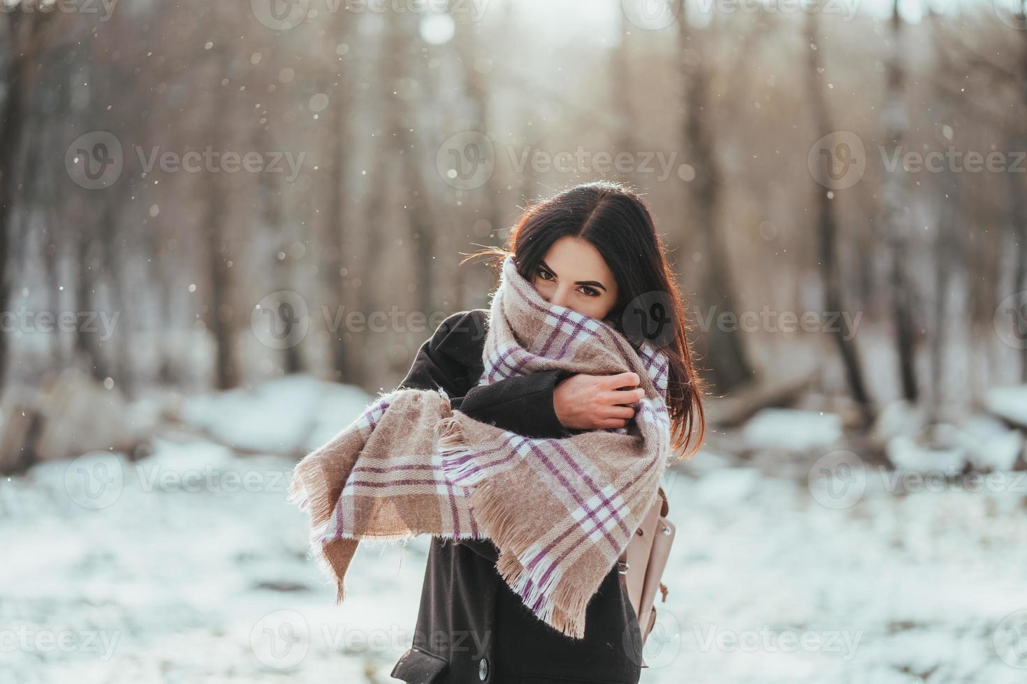 Young beautiful model posing in winter forest. stylish fashion portrait photo