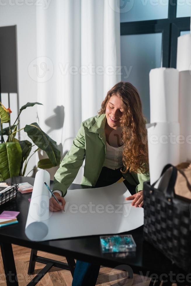 Portrait of young woman at her workplace in the home photo