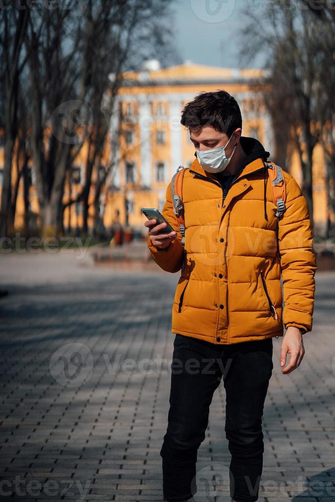 Guy in a park with a cotton mask as an extra protection photo