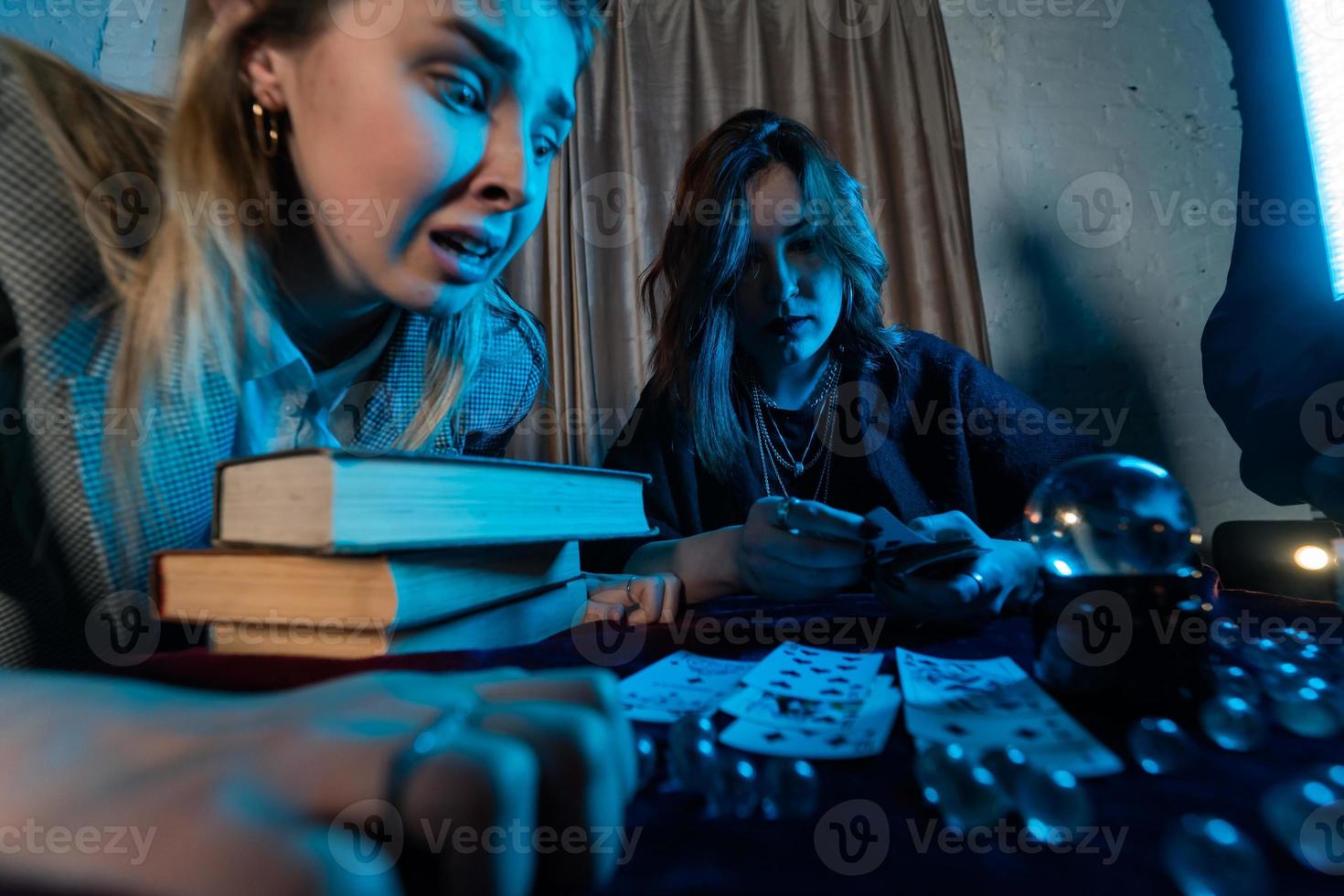 Fortune teller forecasting the future to woman with cards photo