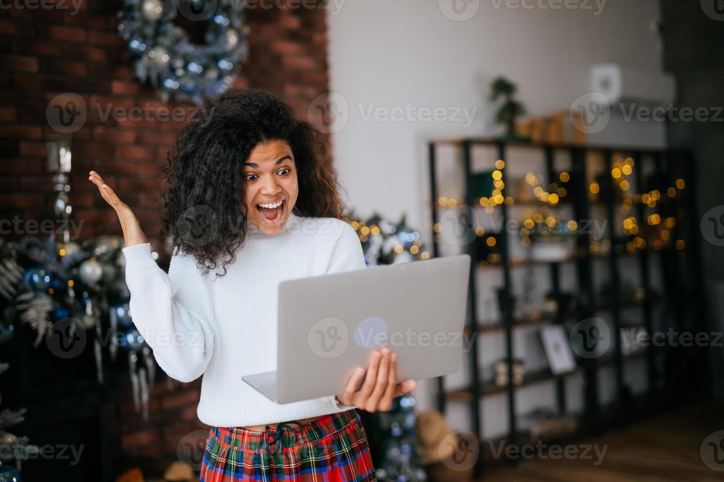 Nice attractive lovely overjoyed crazy woman holding in hands laptop, goal achievement photo