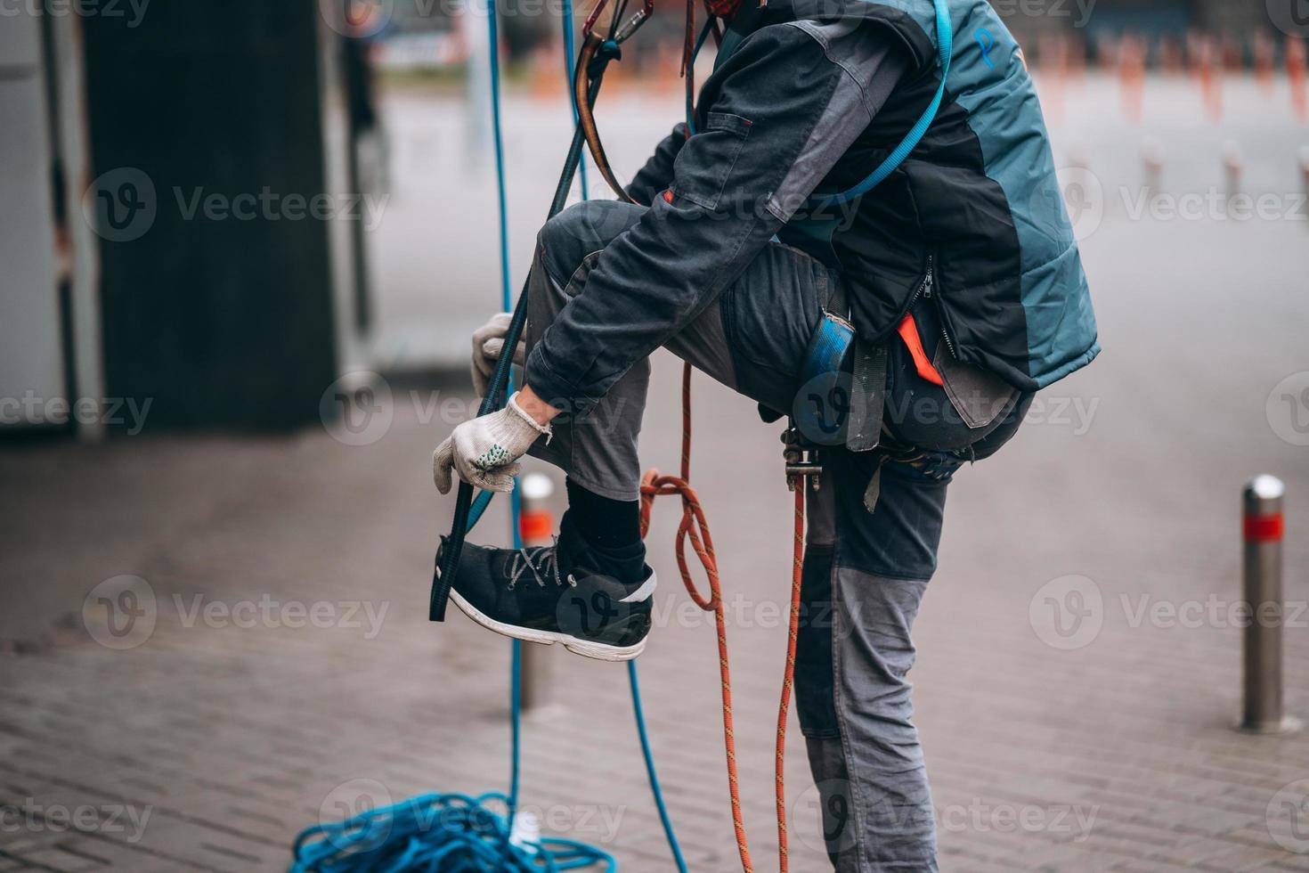 Worker climber preparing for work at height. photo