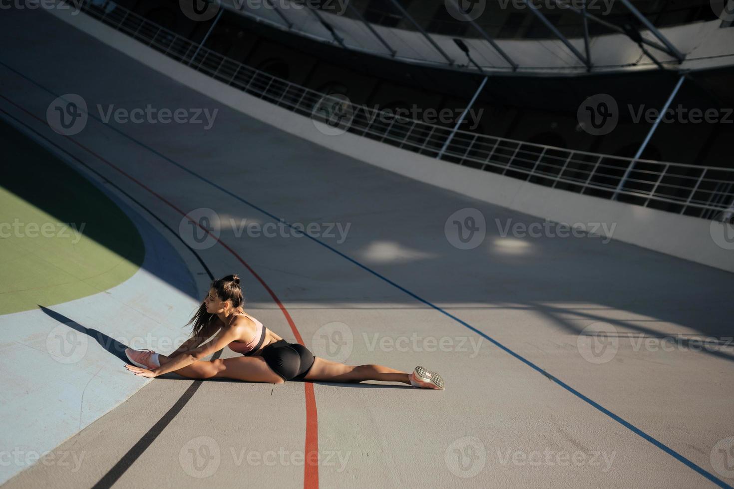 Young attractive female fitness woman performing a twine photo