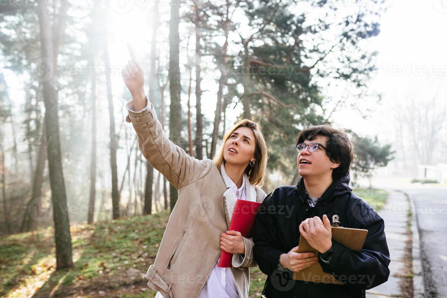 Scientists are studying plant species and inspect trees in the forest. photo