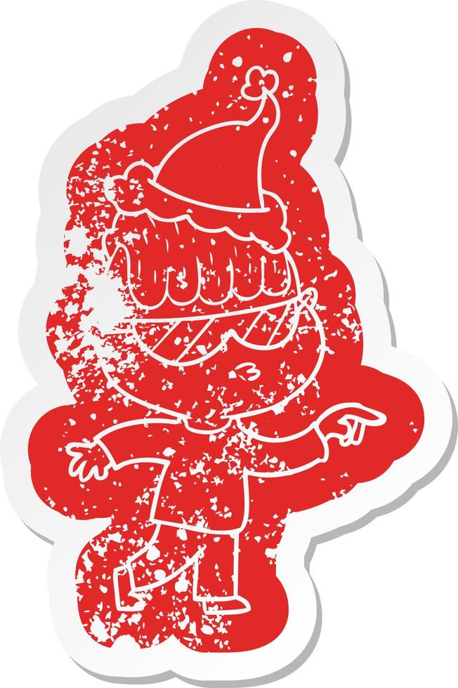 cartoon distressed sticker of a boy wearing sunglasses pointing wearing santa hat vector