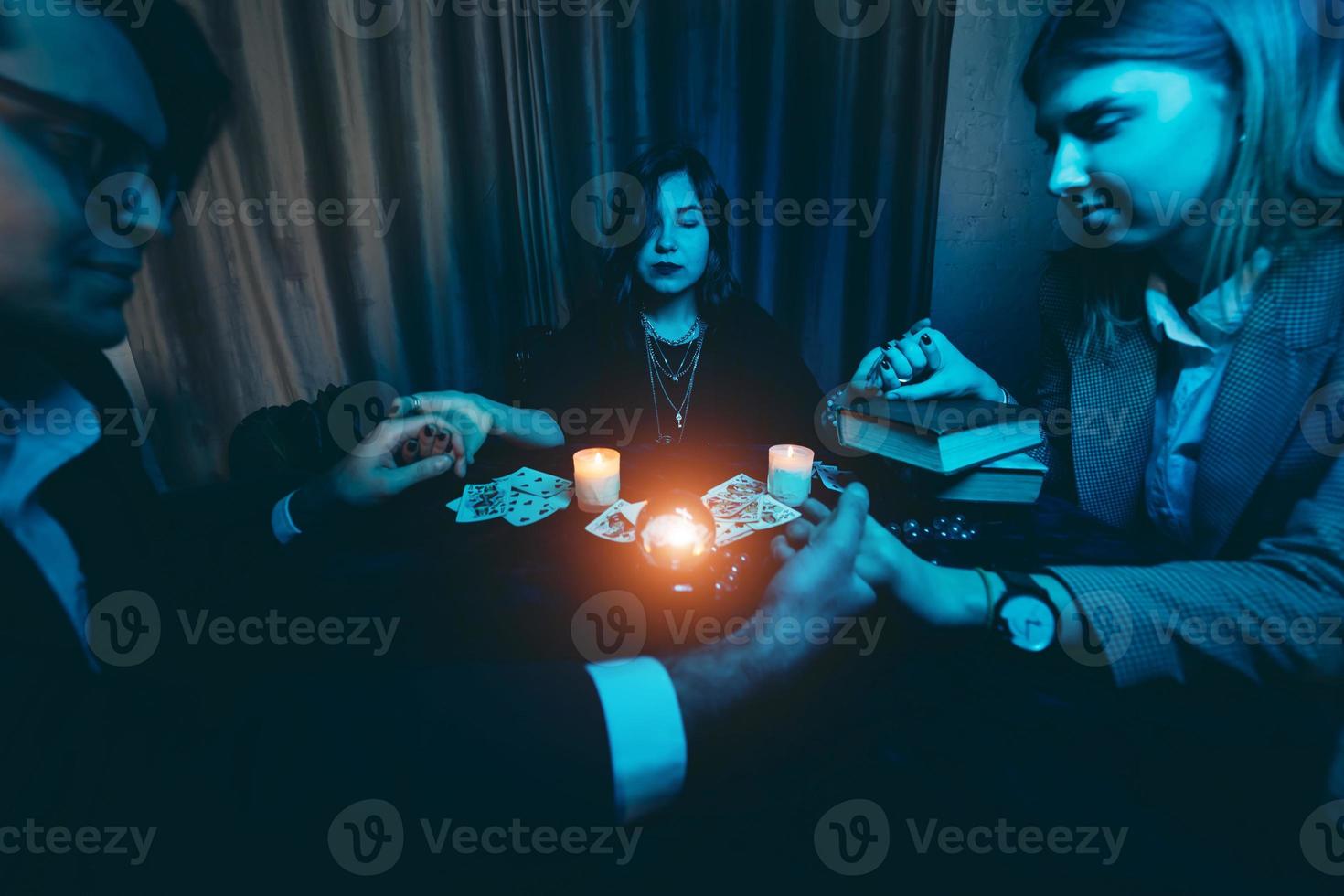 People hold hands of night at table with candles photo