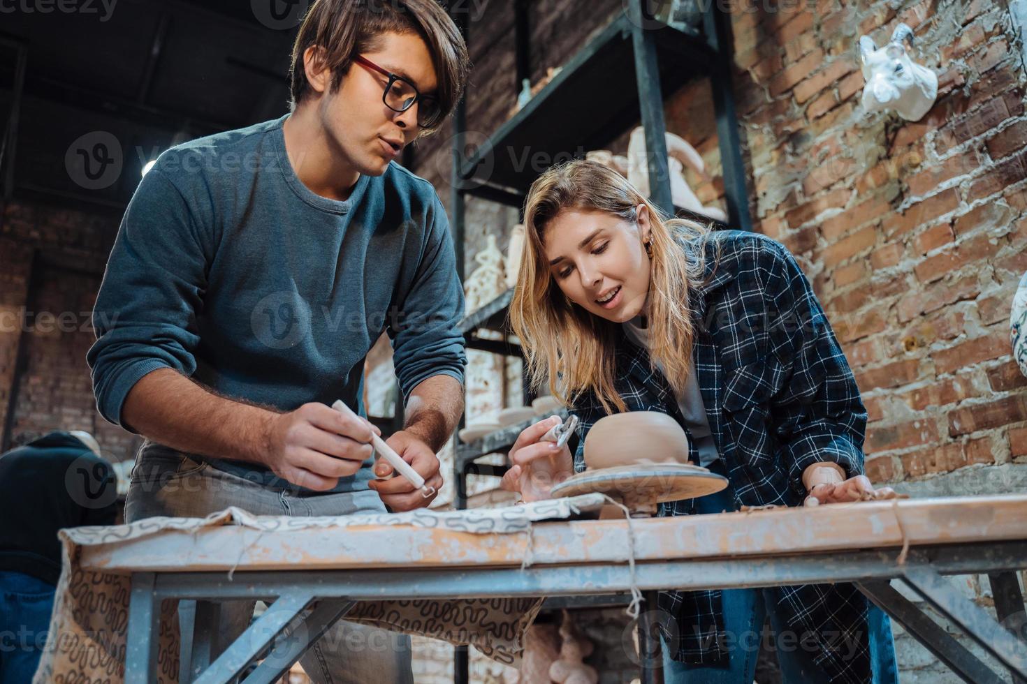 Making a handmade clay pot in the workshop. Pottery lesson, hobby. photo