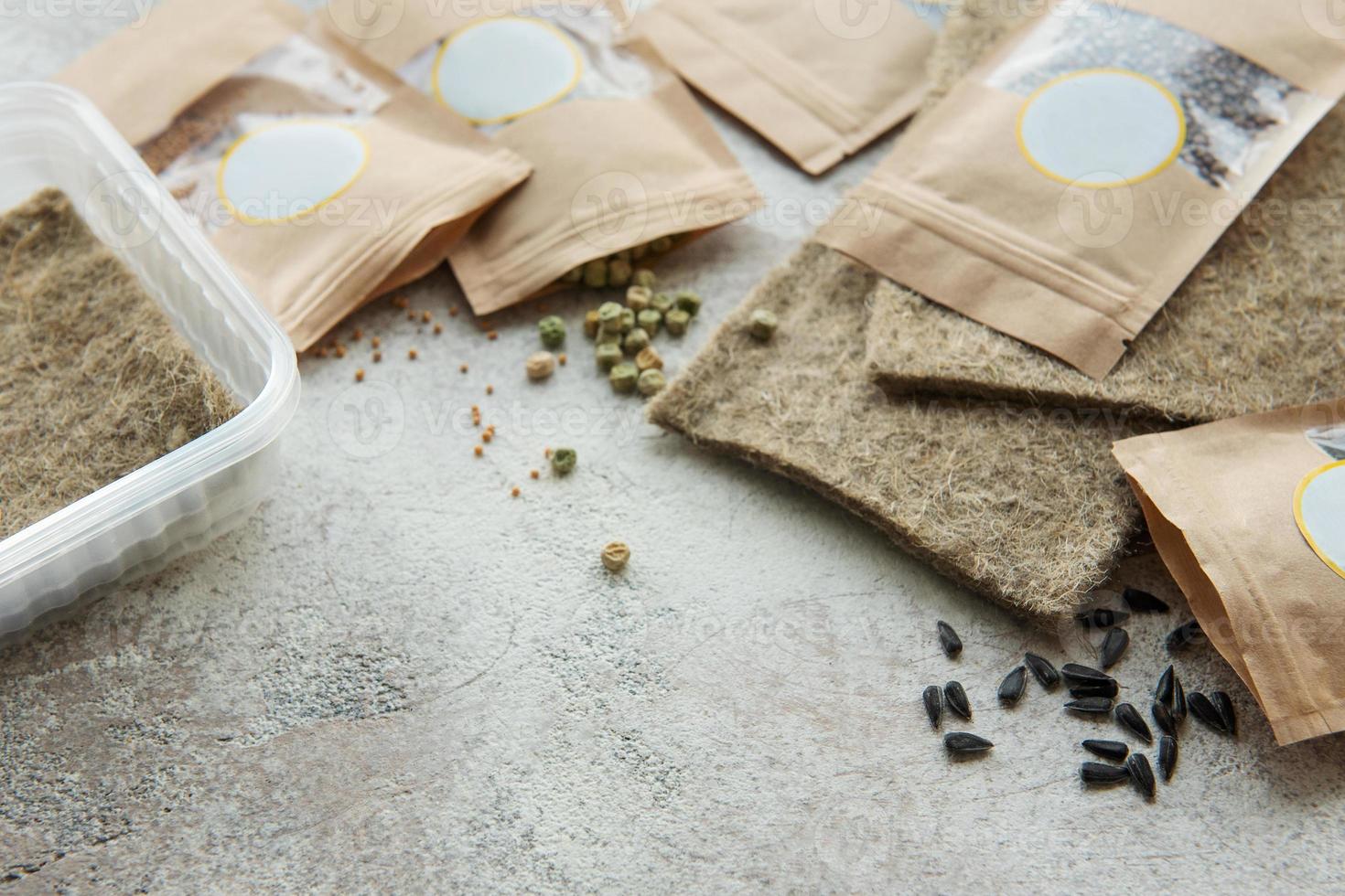 Microgreen seeds in paper bags and equipment for sowing microgreens. photo