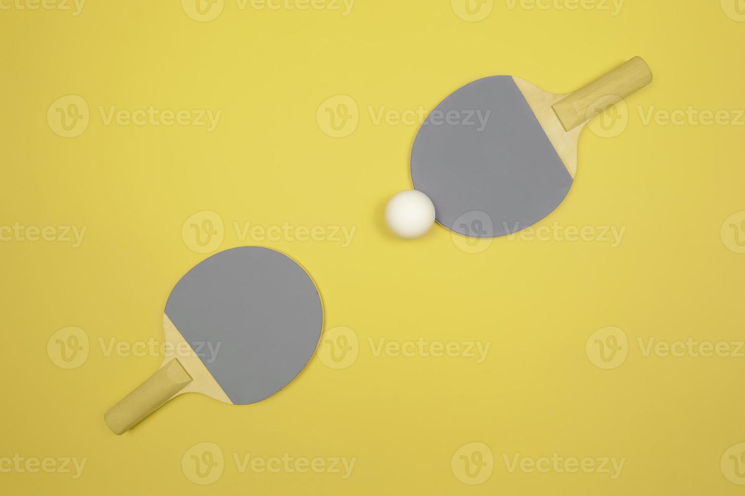 Demonstrating trendy colors of the year 2021. Grey and yellow. Table tennis racket photo