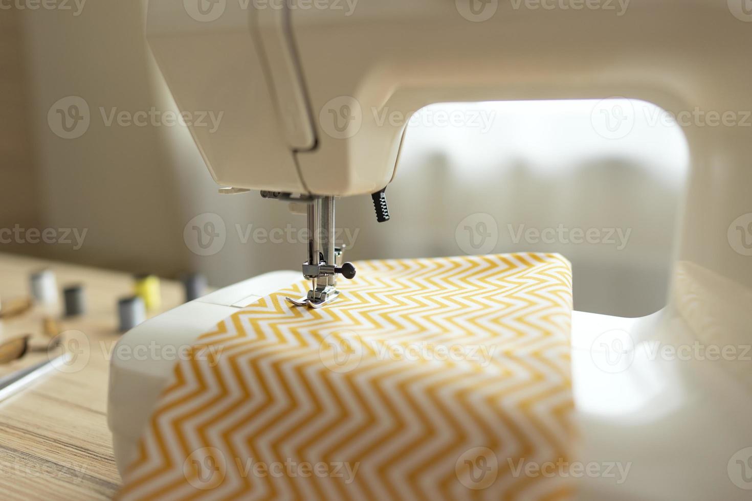 A sewing machine stands on a table photo