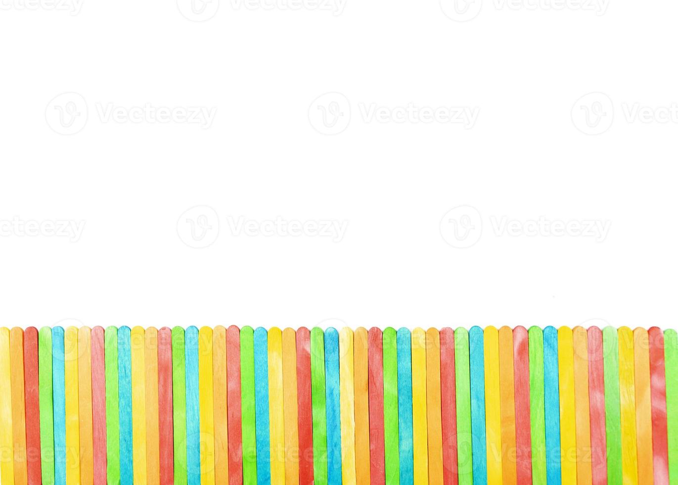 Multicolored sticks lie as a fence photo