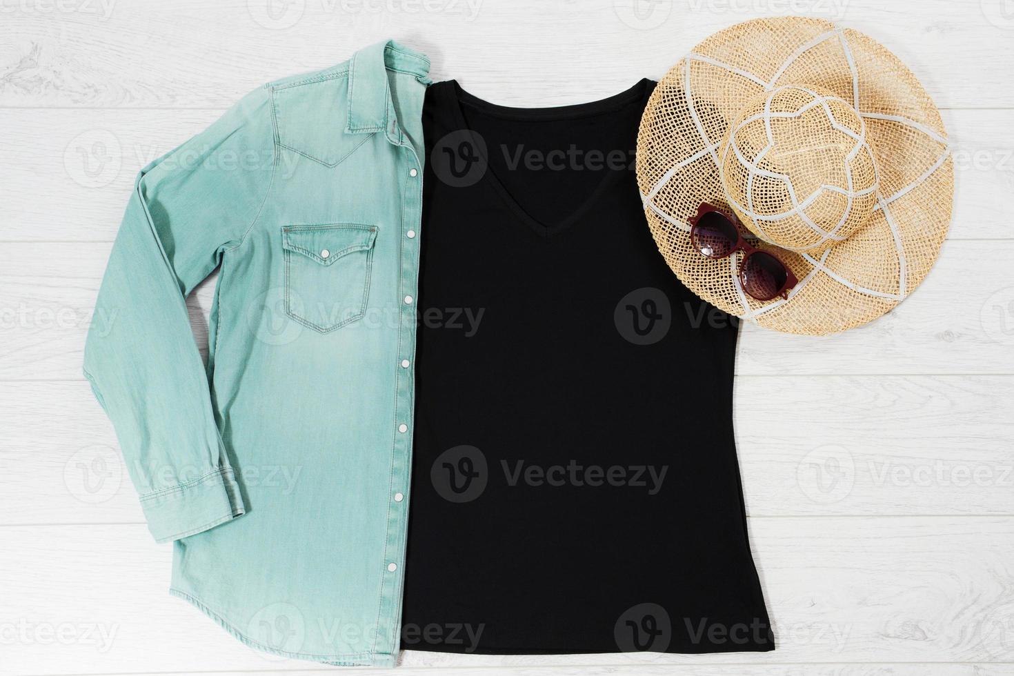 Black closeup t shirt mock up flat lay on white wooden background. Top view and copy space. Mockup t-shirt and summertime. Template blank shirt. photo