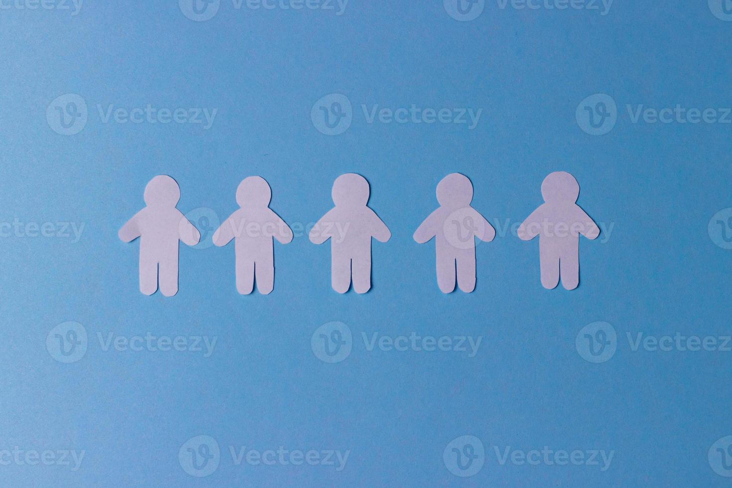 People cut out of paper. White human silhouettes in a row. The concept of communication, teamwork, society photo