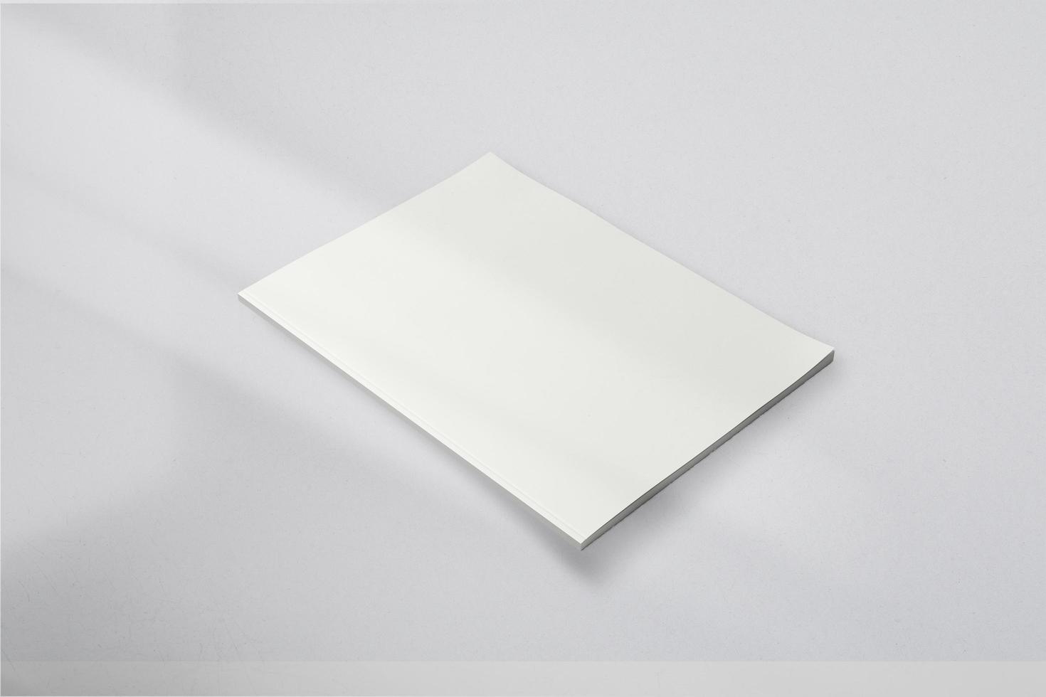 Realistic top view cover and opened portrait A4 or A5 magazine or brochure booklet for stationery and branding. Mockup template isolated light grey background and leaf shadow overlay. 3D rendering. photo
