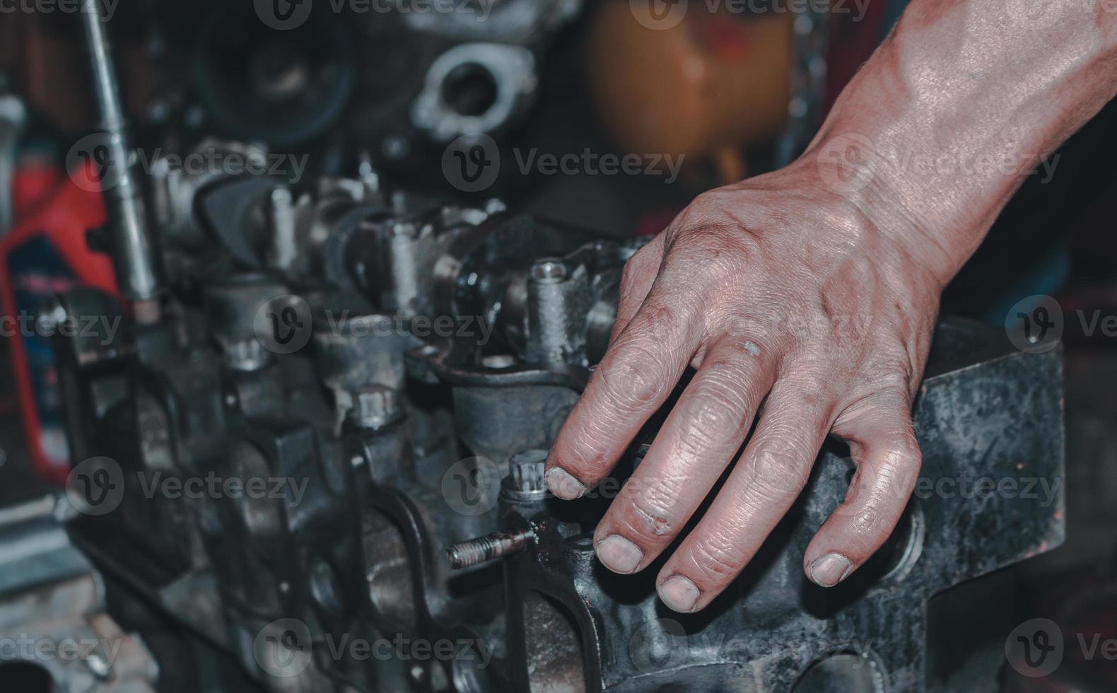 The mechanic is checking the engine. photo