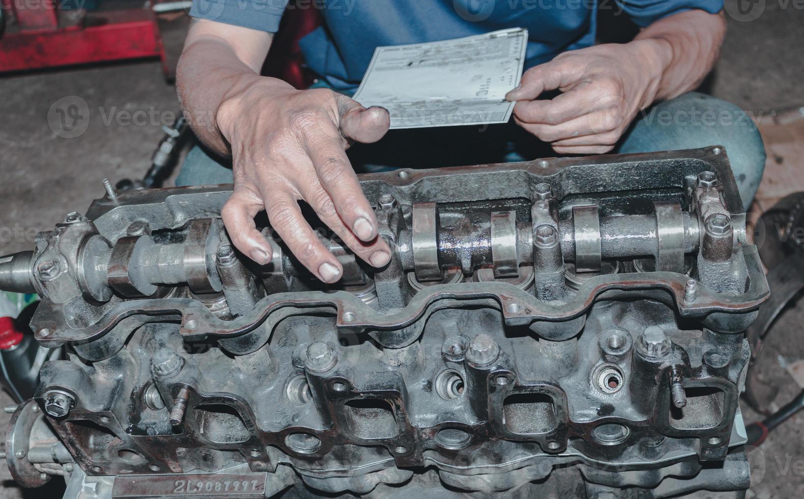 The mechanic is checking the engine. photo