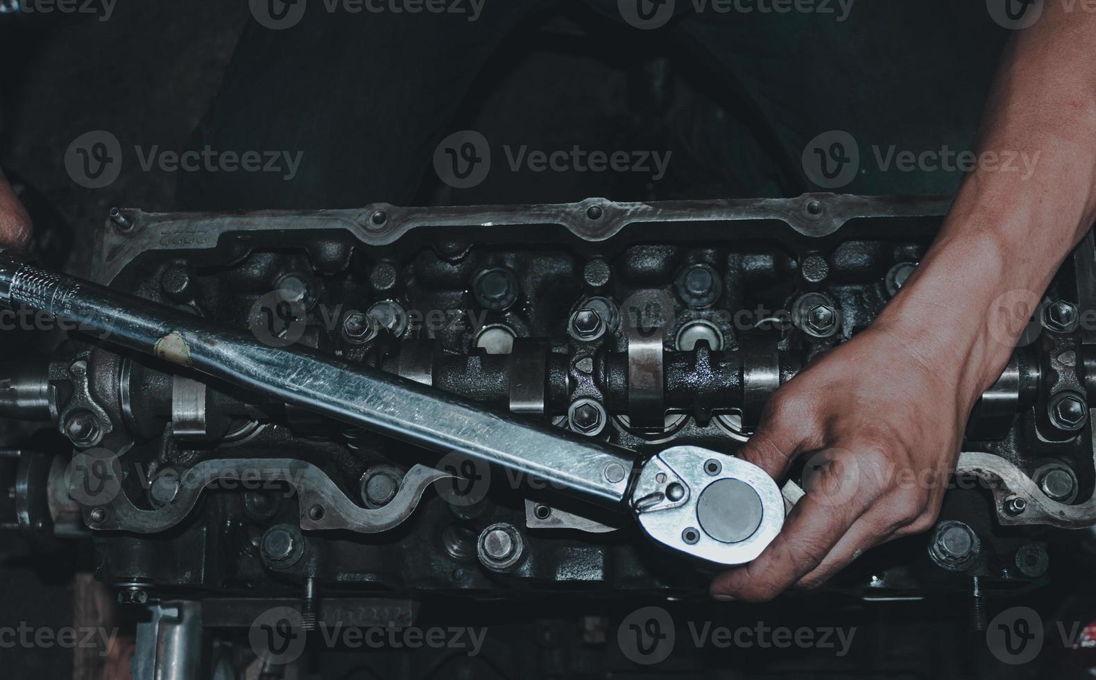 The mechanic is checking the engine. photo