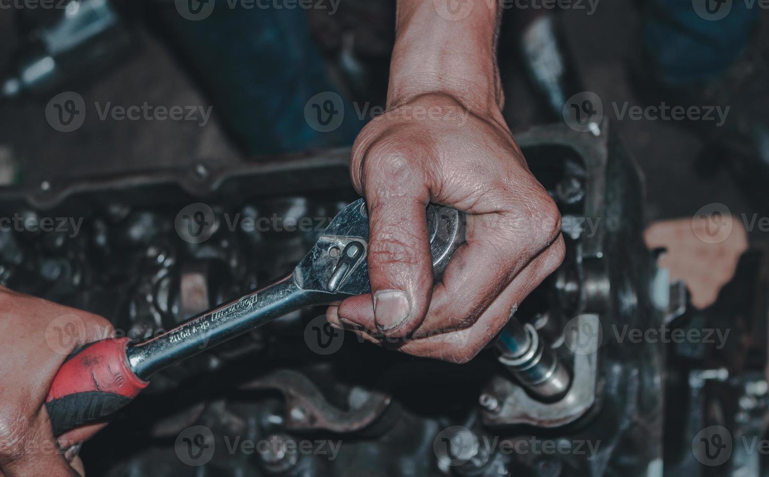 The mechanic is checking the engine. photo