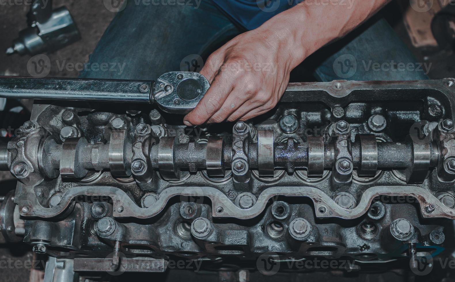 The mechanic is checking the engine. photo