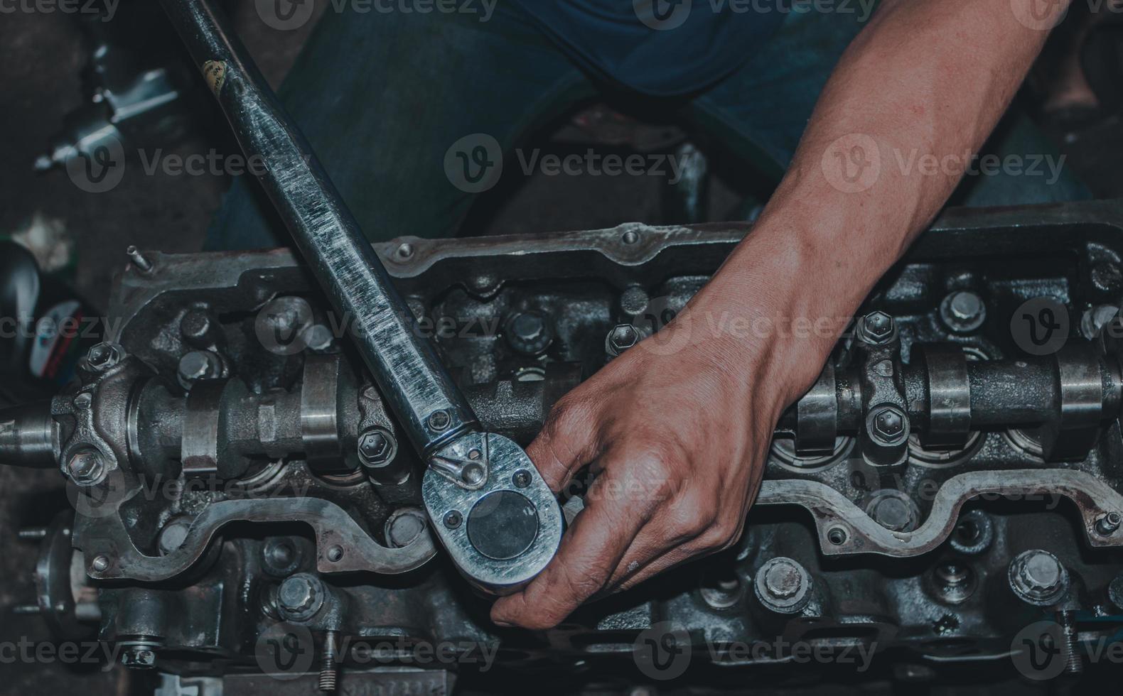The mechanic is checking the engine. photo