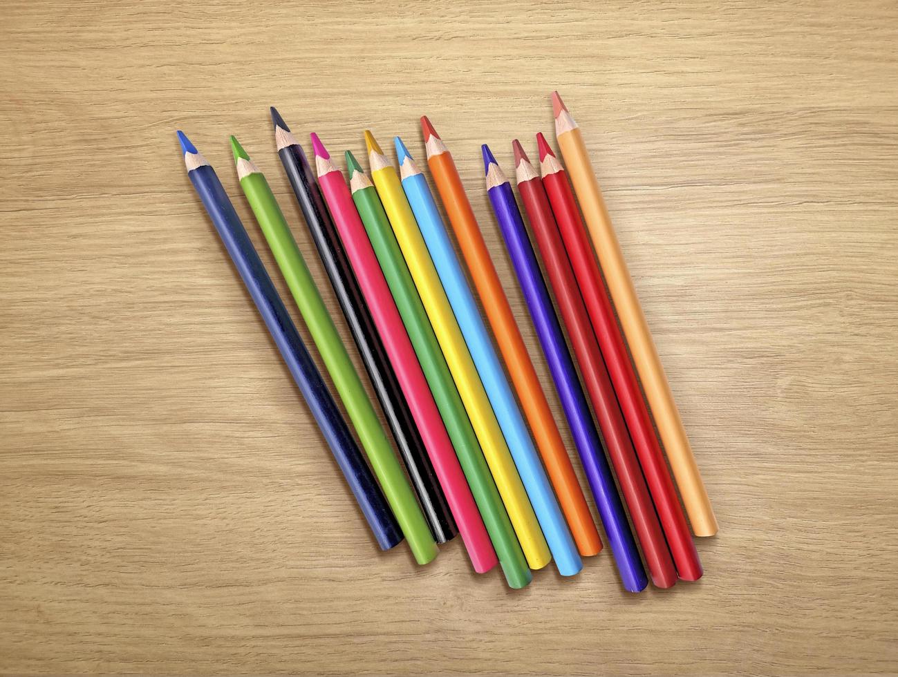 colored pencils on a wooden background photo