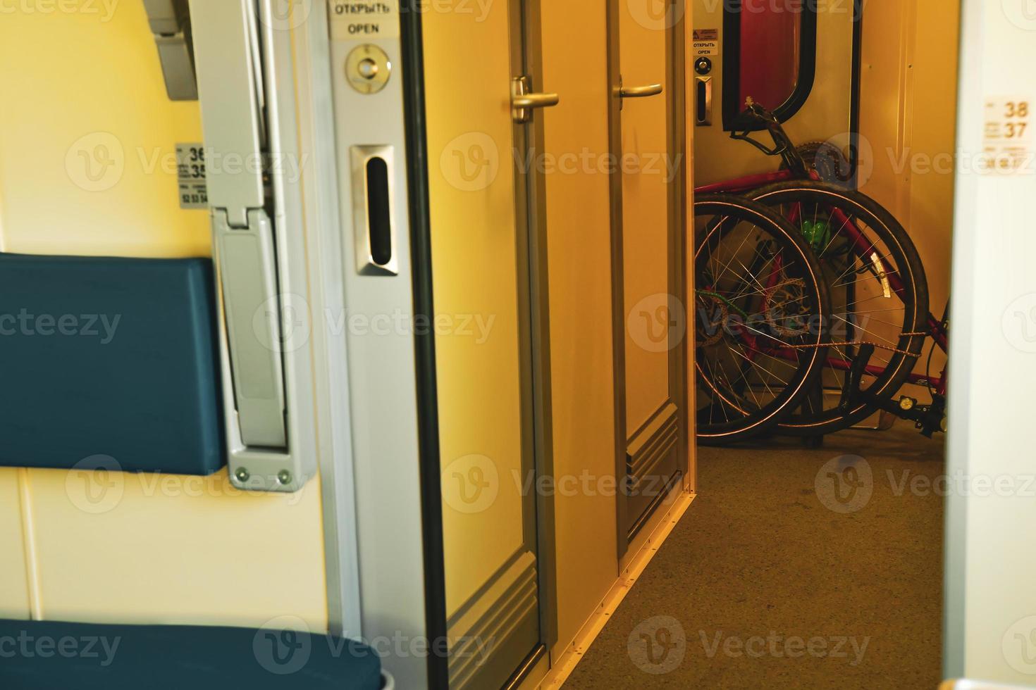 Dissembled bicycle stand in corner in train for transportation purpose photo