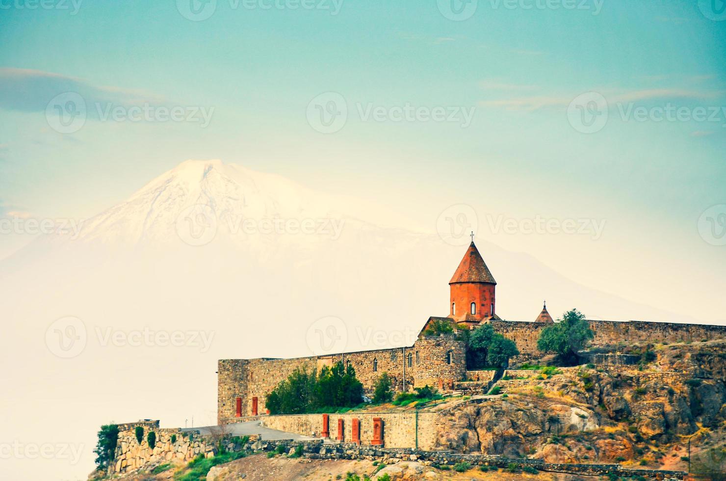 Cinematic view historical landmark in Armenia - Khor Virap monastery with Ararat mountain peak background at sunrise photo