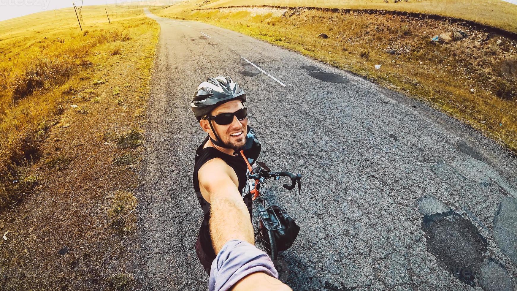 Inspirational smartphone selfie portrait excited joyful caucasian male cyclist standing by touring bicycle looking to camera smiley face. Stand confident enjoy carefree lifestyle photo