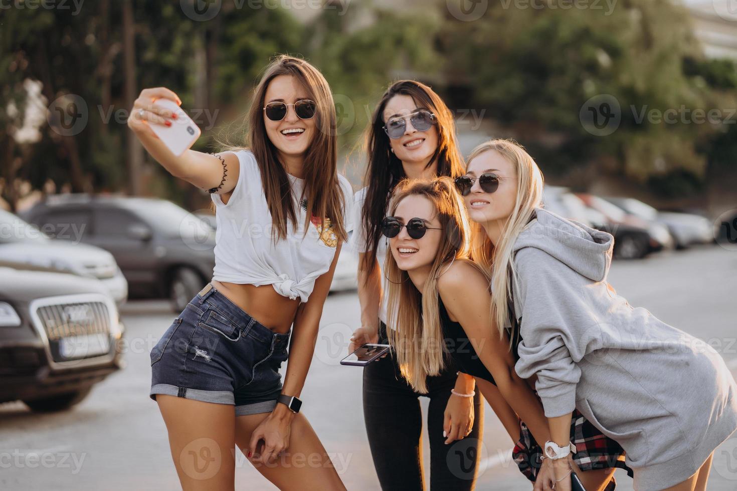 Four young women taking a selfie and have fun photo