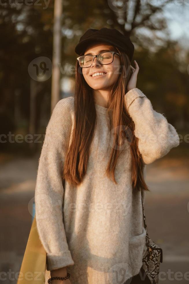 Attractive, young brunette with long hair walking autumn park. photo