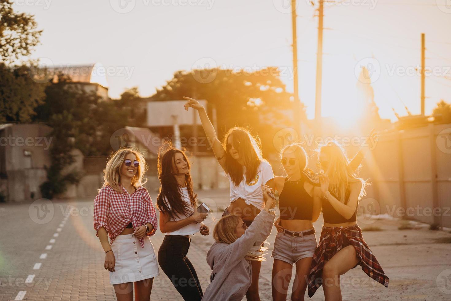 Six young women dance in a car park photo