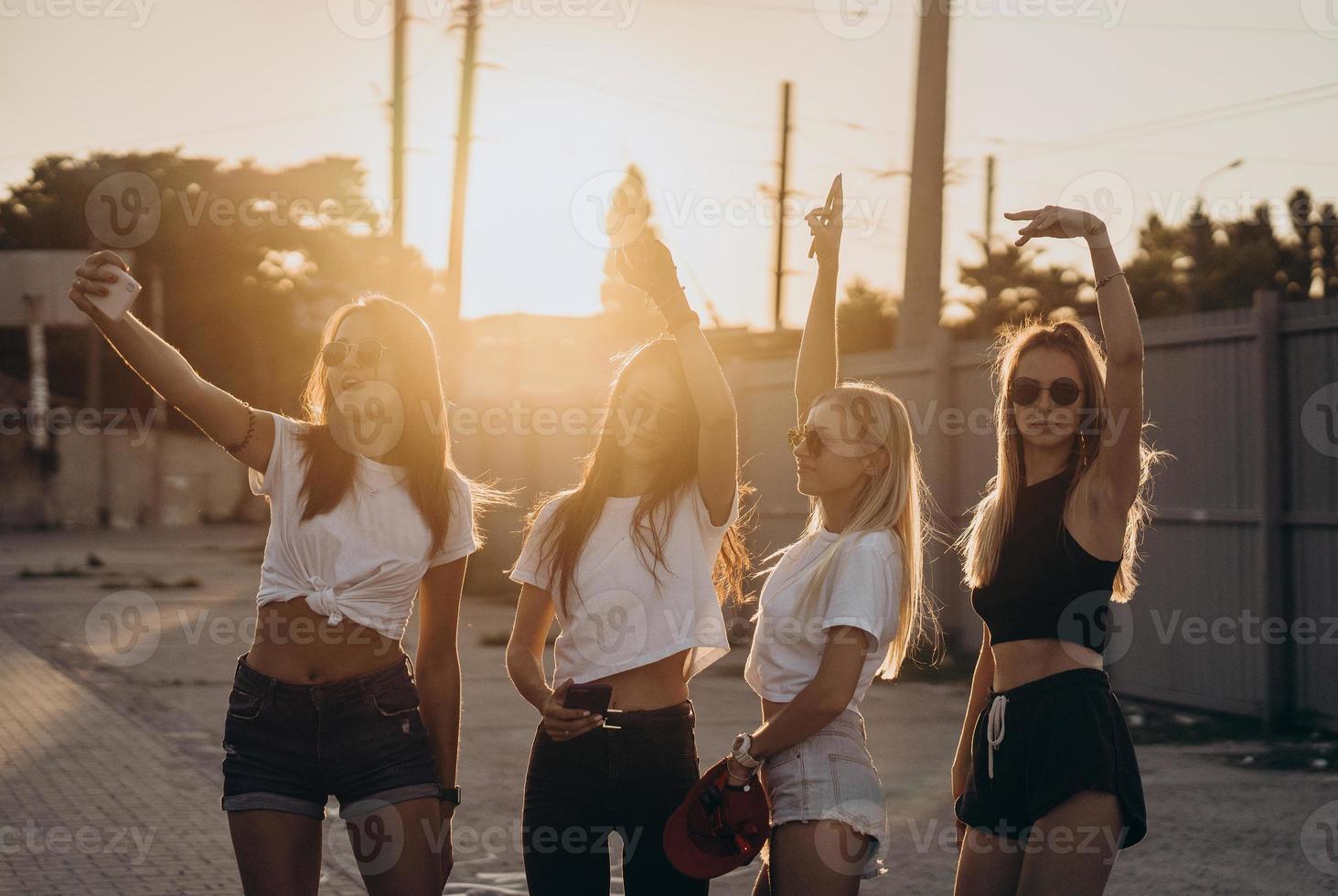 Four young girls taking a selfie and have fun photo