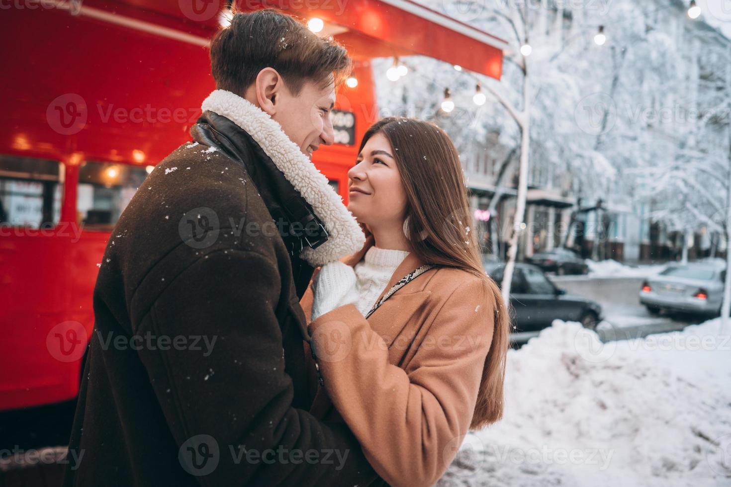 beautiful young couple posing by the old bus photo