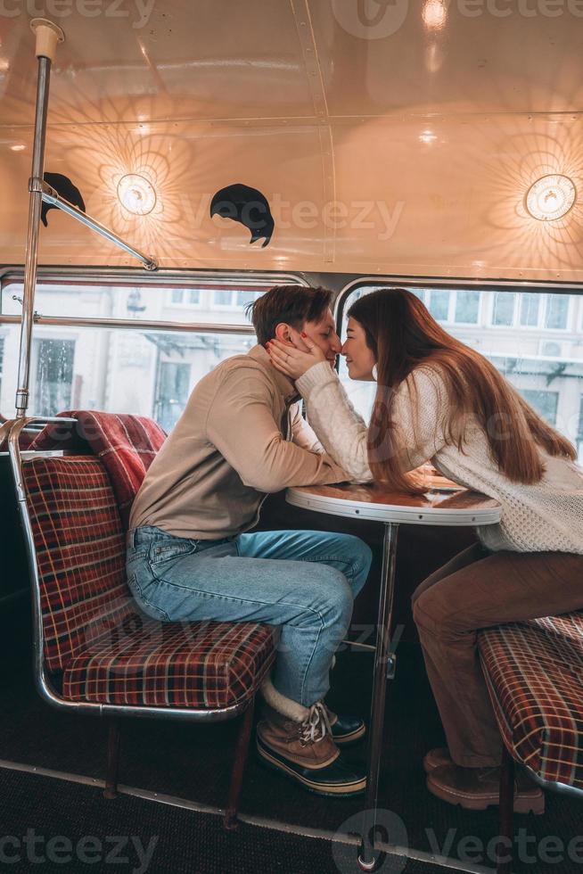 Loving young couple in winter time sitting in a cafe photo