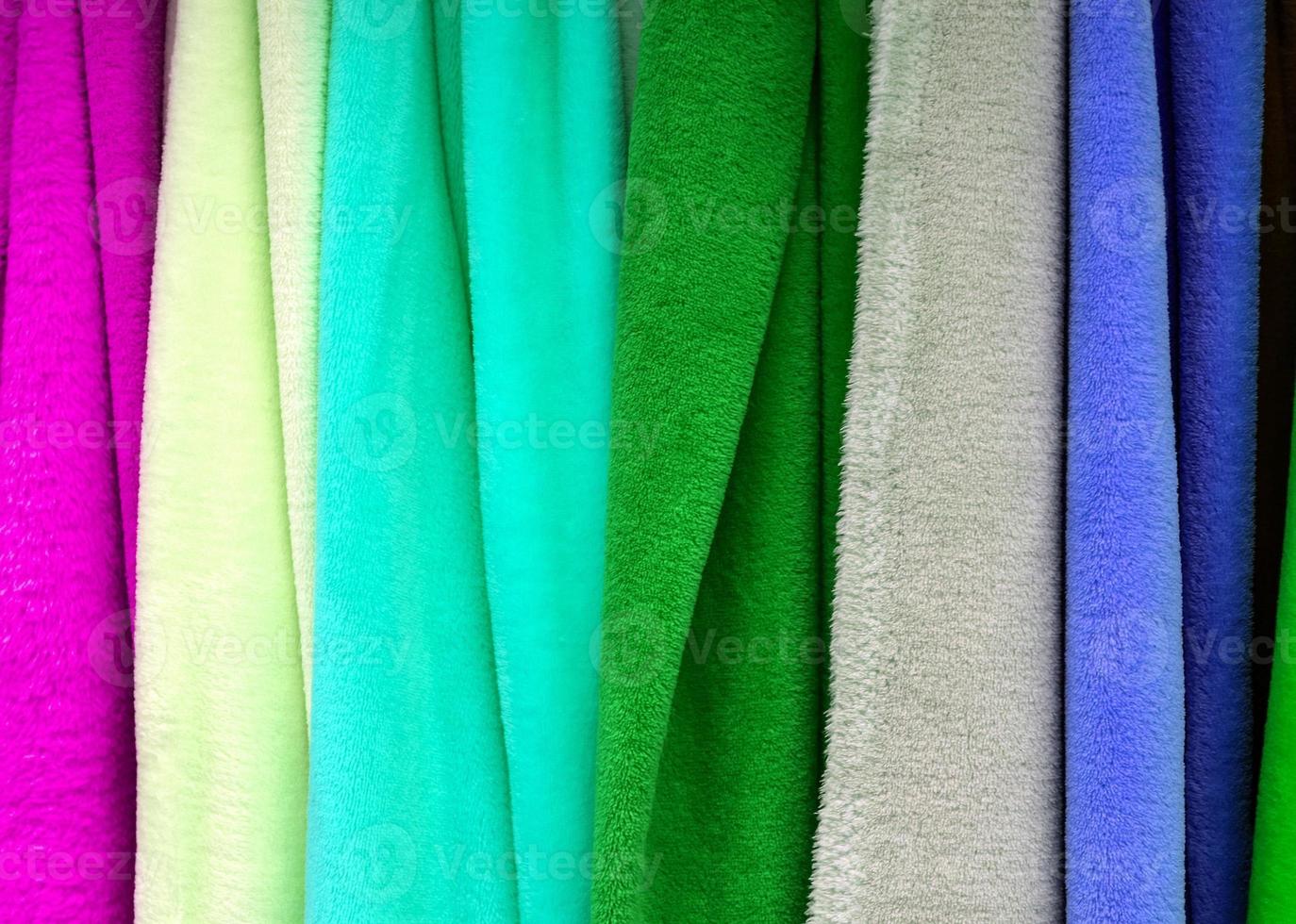 Detailed close up view on samples of cloth and fabrics in different colors found at a fabrics market photo