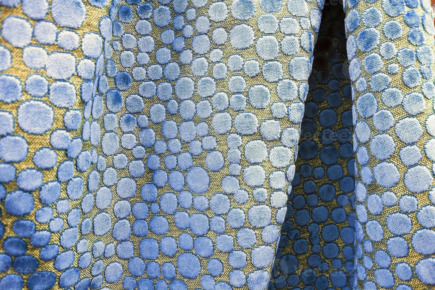 Detailed close up view on samples of cloth and fabrics in different colors found at a fabrics market photo