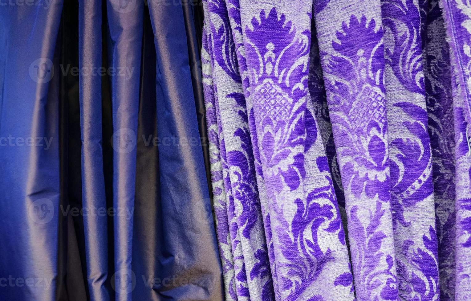 Detailed close up view on samples of cloth and fabrics in different colors found at a fabrics market photo