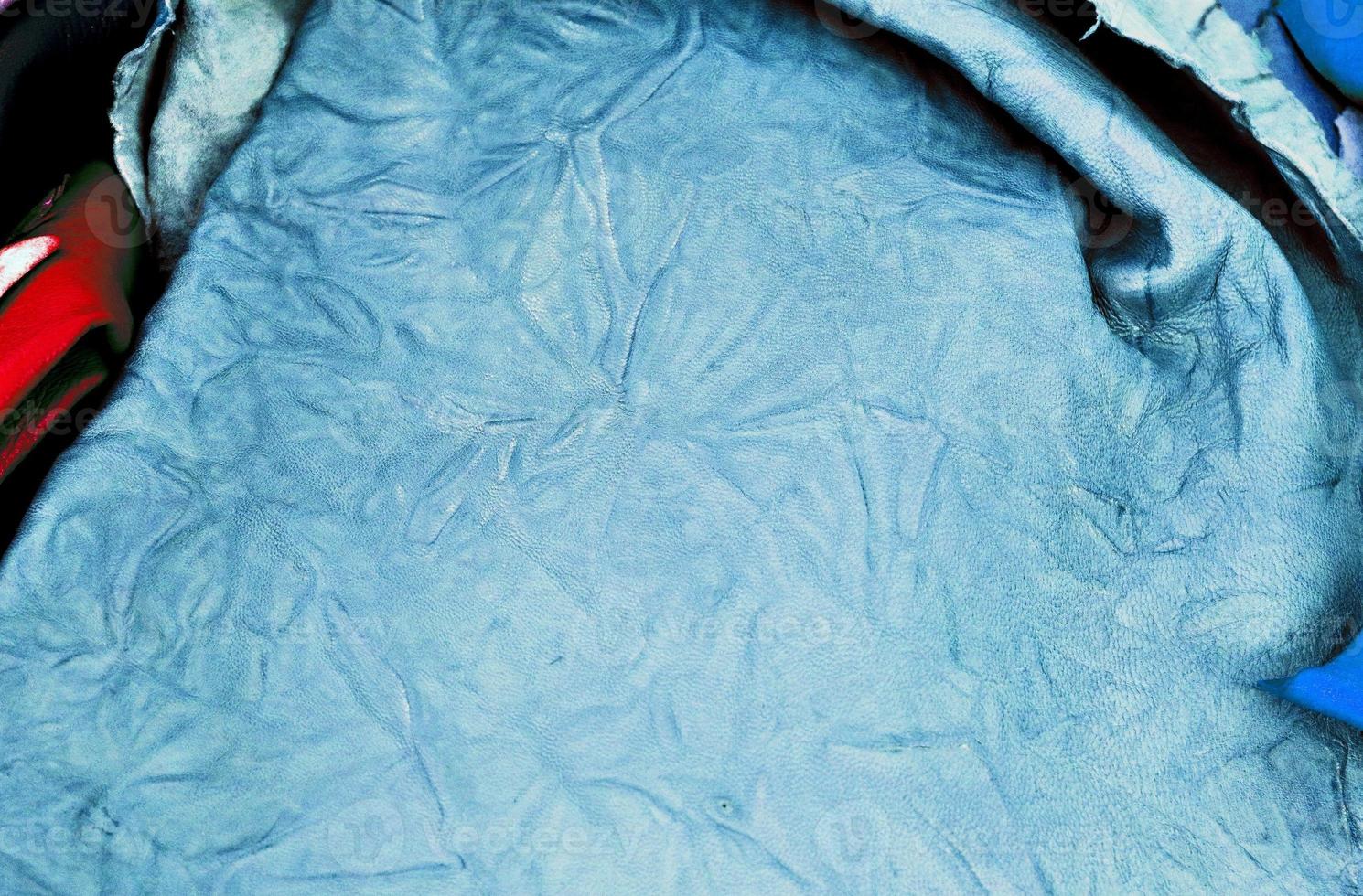 Detailed close up view on samples of cloth and fabrics in different colors found at a fabrics market photo