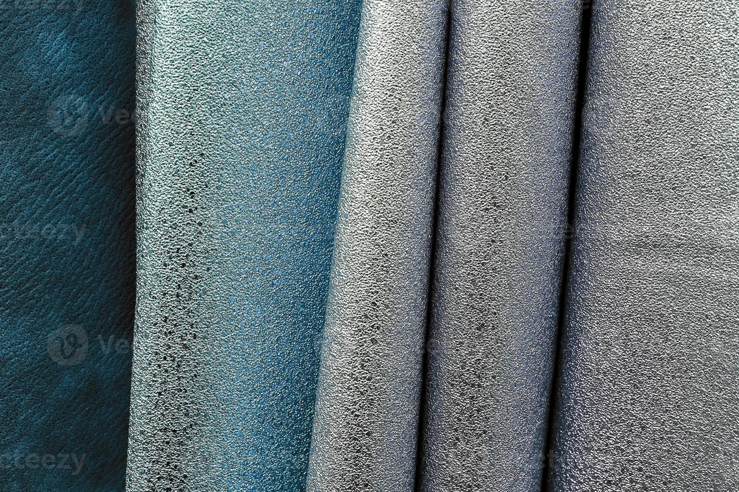 Detailed close up view on samples of cloth and fabrics in different colors found at a fabrics market photo