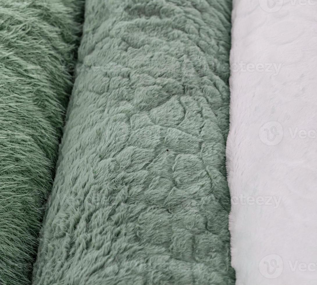 Detailed close up view on samples of cloth and fabrics in different colors found at a fabrics market photo