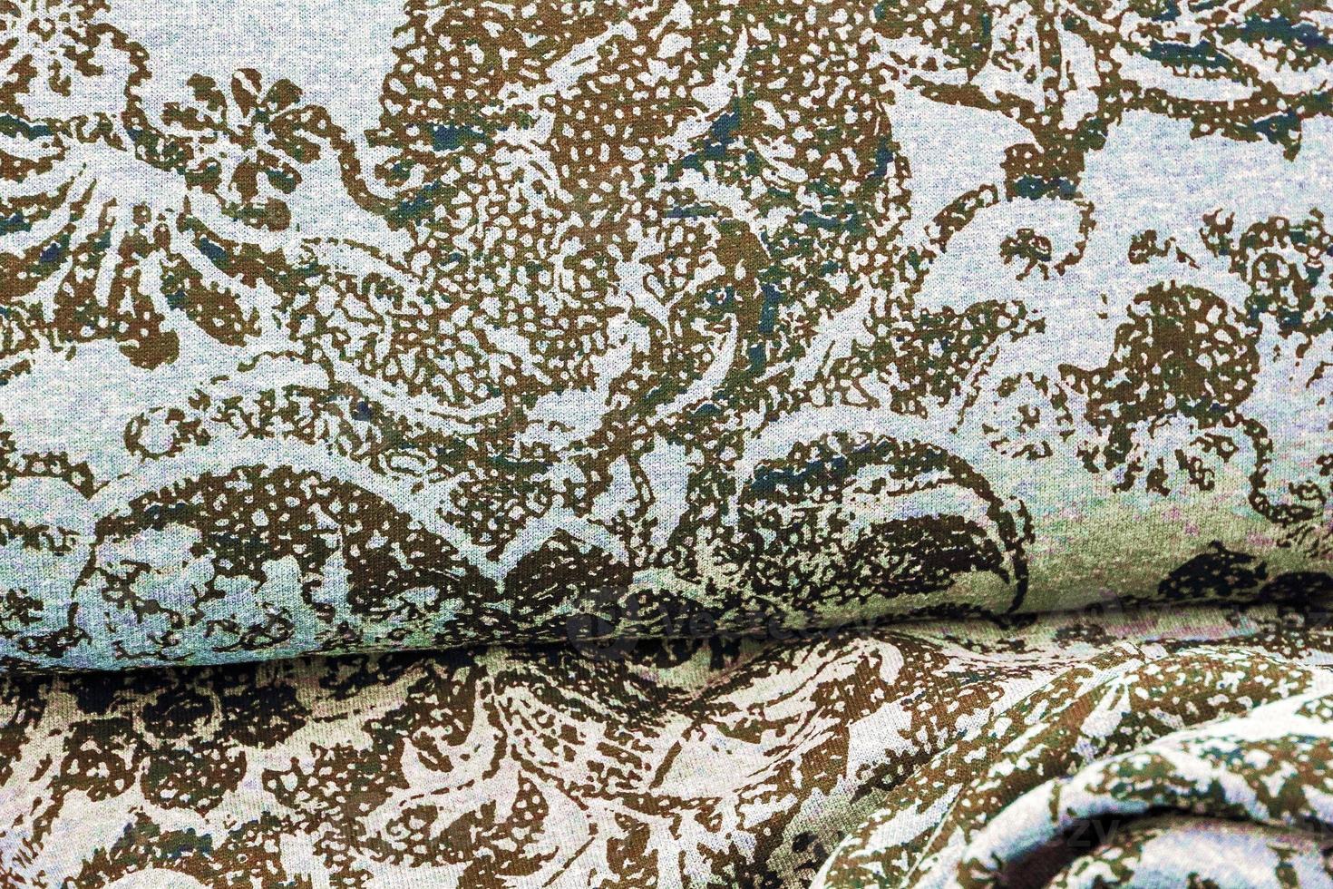 Detailed close up view on samples of cloth and fabrics in different colors found at a fabrics market photo