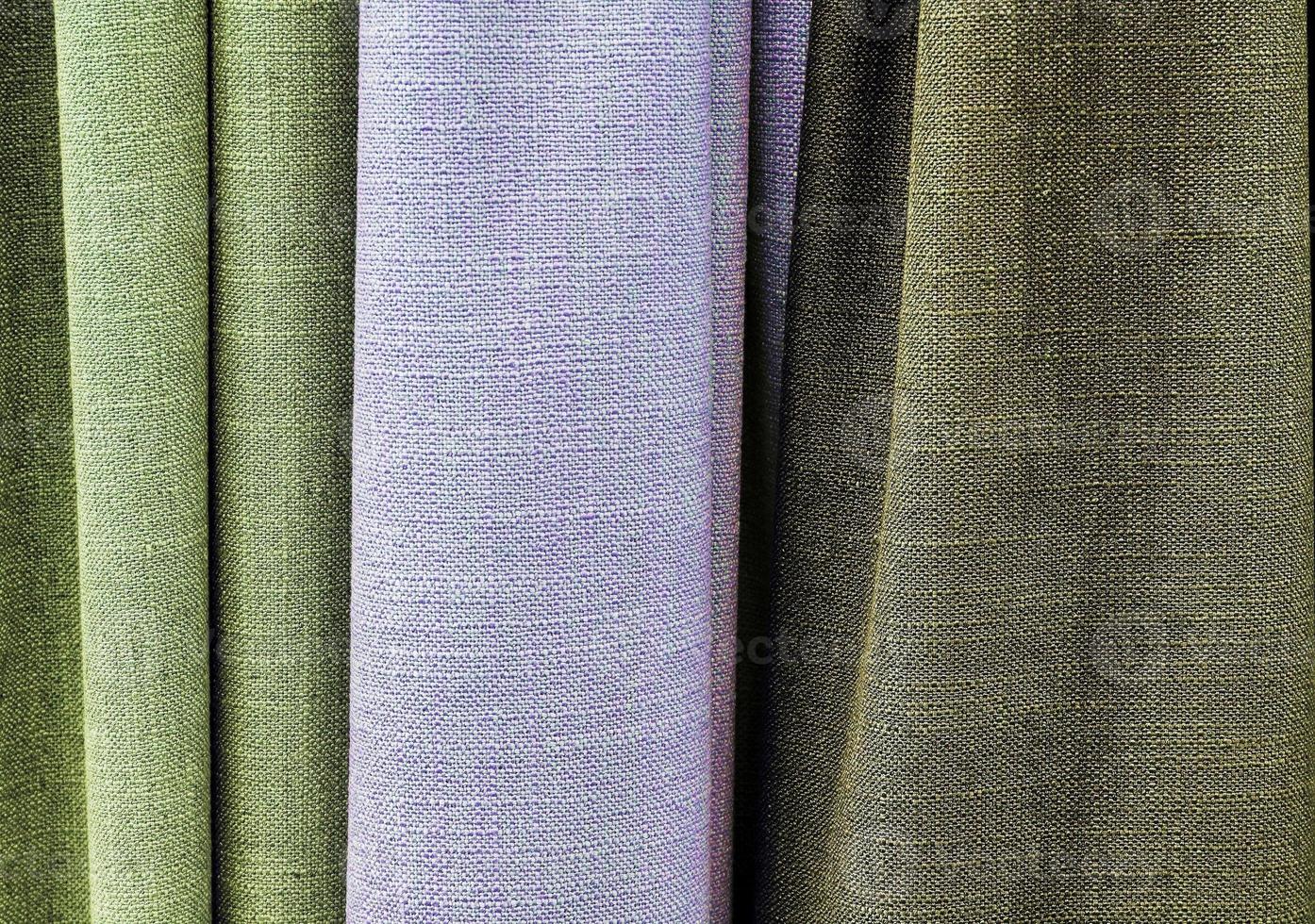 Detailed close up view on samples of cloth and fabrics in different colors found at a fabrics market photo