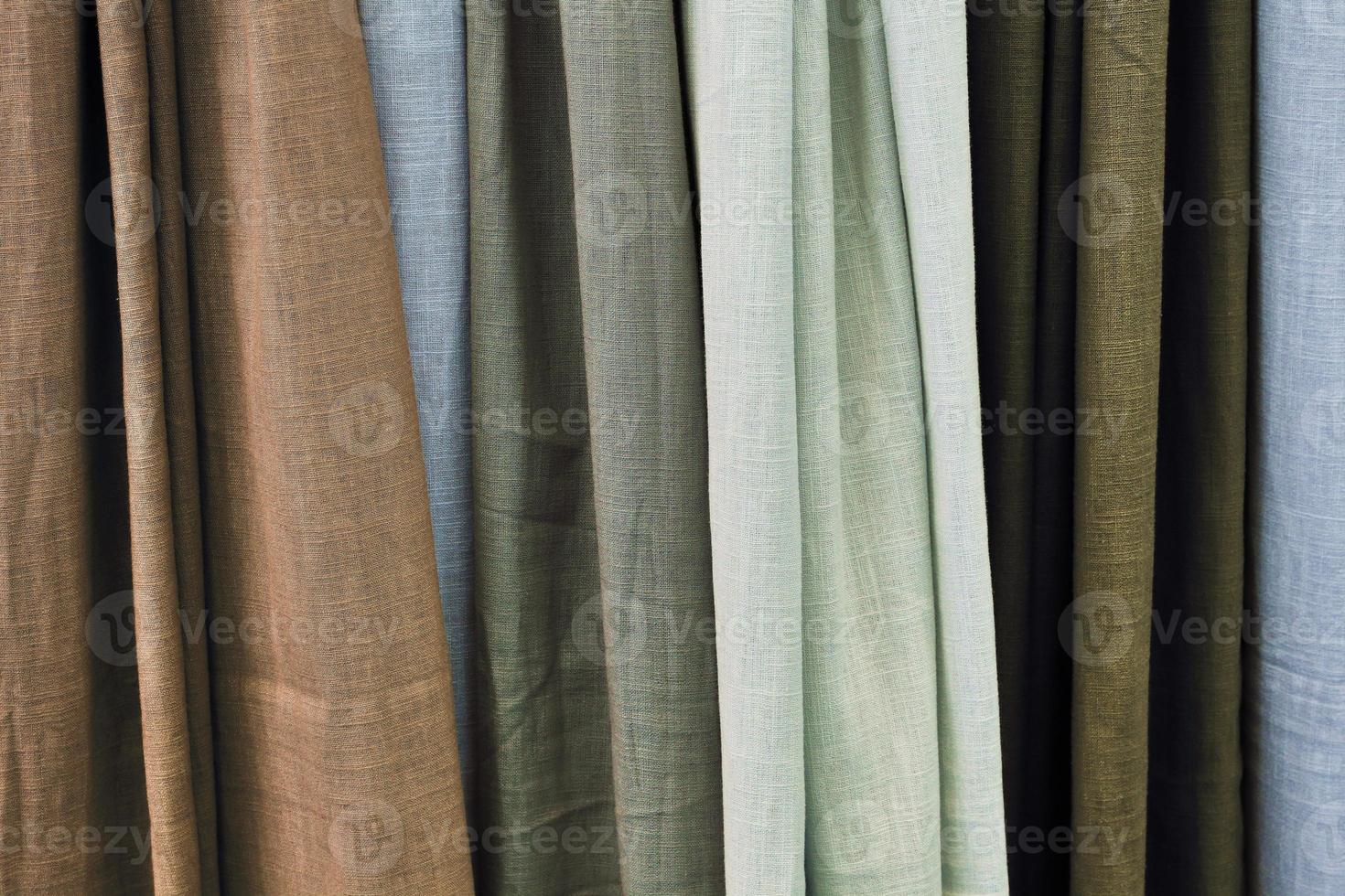 Detailed close up view on samples of cloth and fabrics in different colors found at a fabrics market photo
